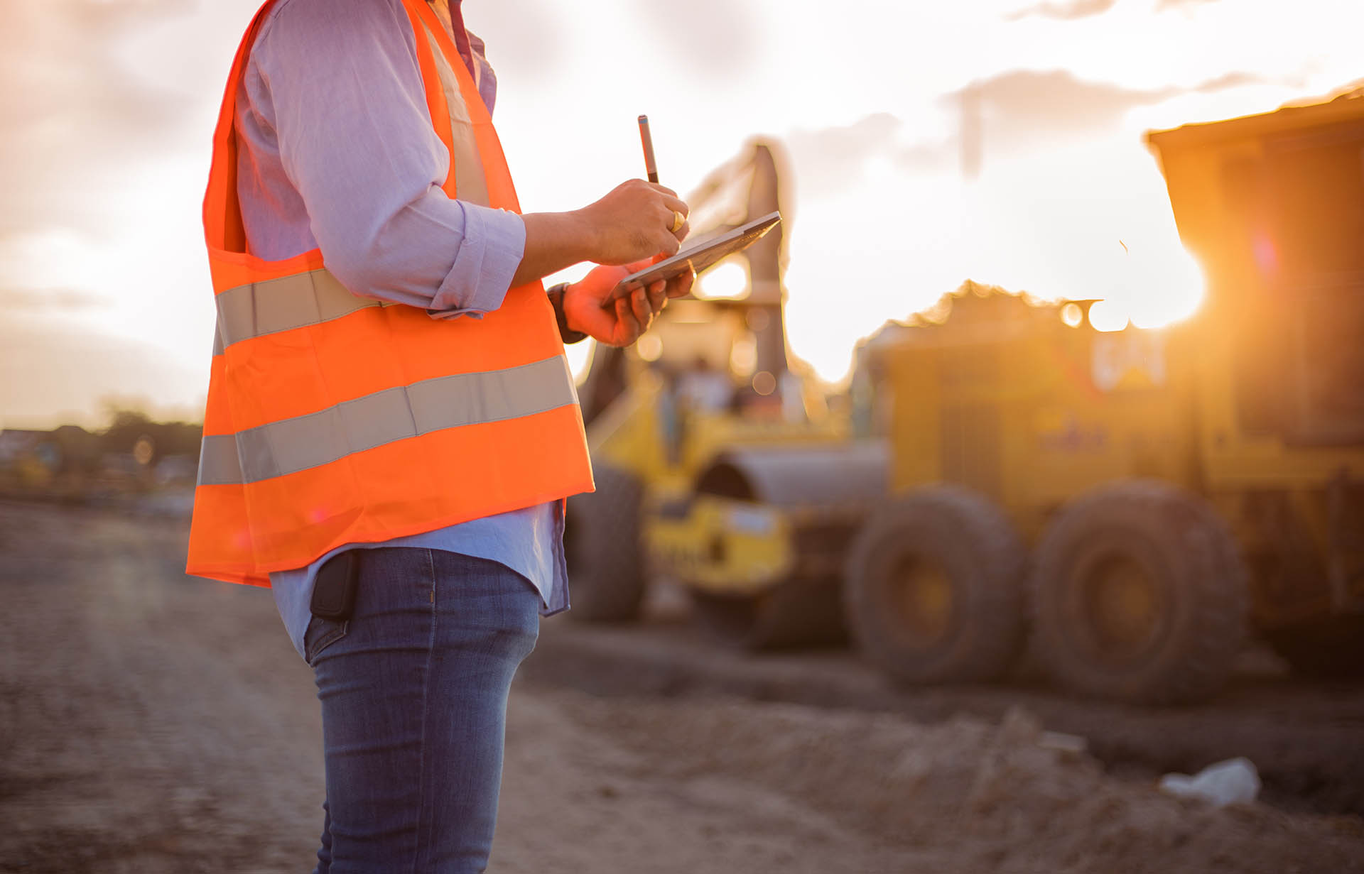 engineer with hardhat using tablet pc computer inspecting.