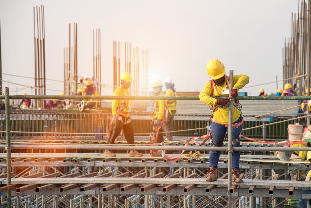 Header image for the Bid Bond vs Performance Bond article showing multiple people working at height on a construction job.