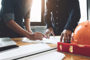 2-men-examining-construction-paperwork