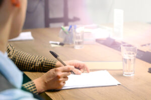 2-men-at-sunny-desk-with-contract