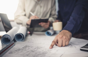 subcontractor-pointing-at-blueprint