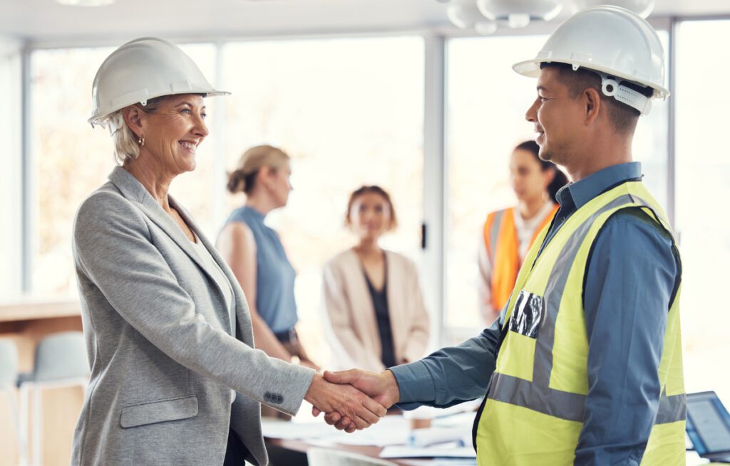 people shaking hands in a construction company.