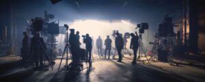 Silhouette people working in studio with equipment and lighting for making movie or commercial.