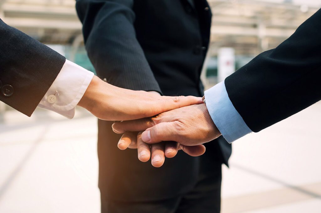 A Three-person handshake.