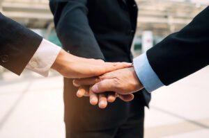 A Three-person handshake.