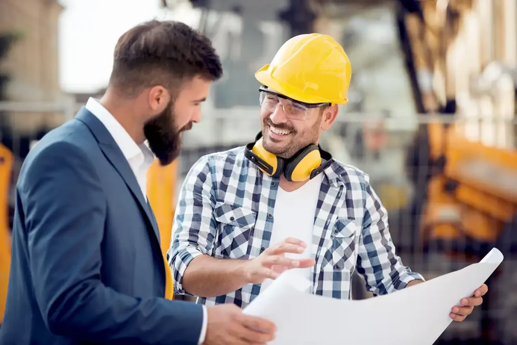contractor and agent looking at blueprints